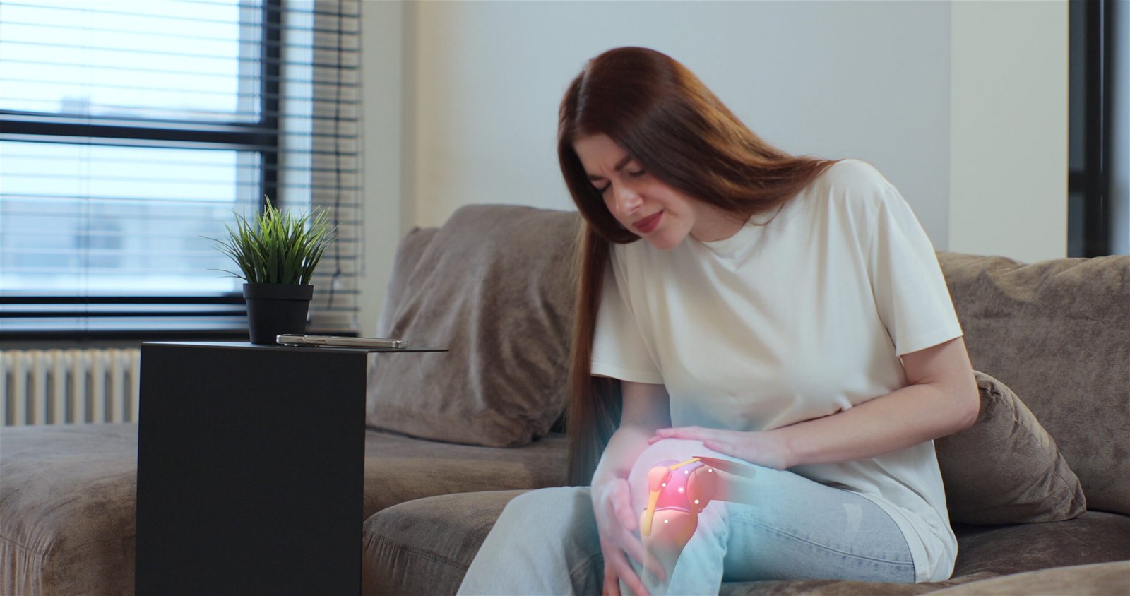 3d-augmented-reality-animation-joint-knee-pain-young-woman-touching-her-knee-feel-pain-doing-massage-sitting-couch-home-people-health-care-problem