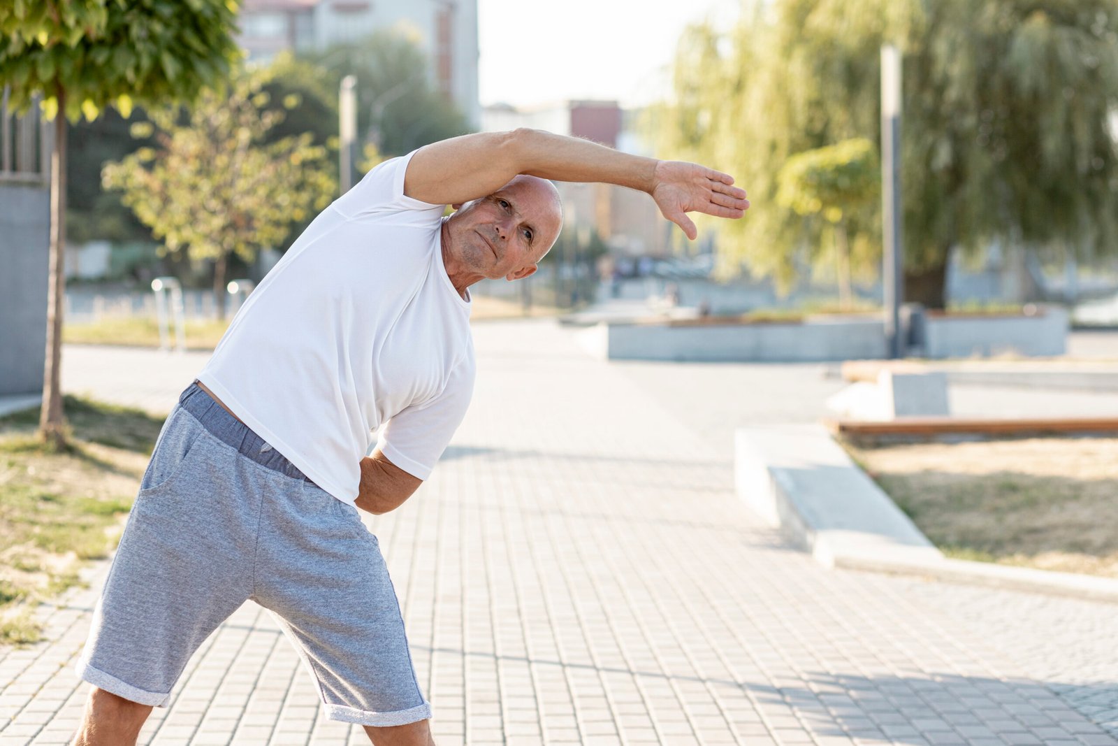 elder-man-stretching-sidewalk