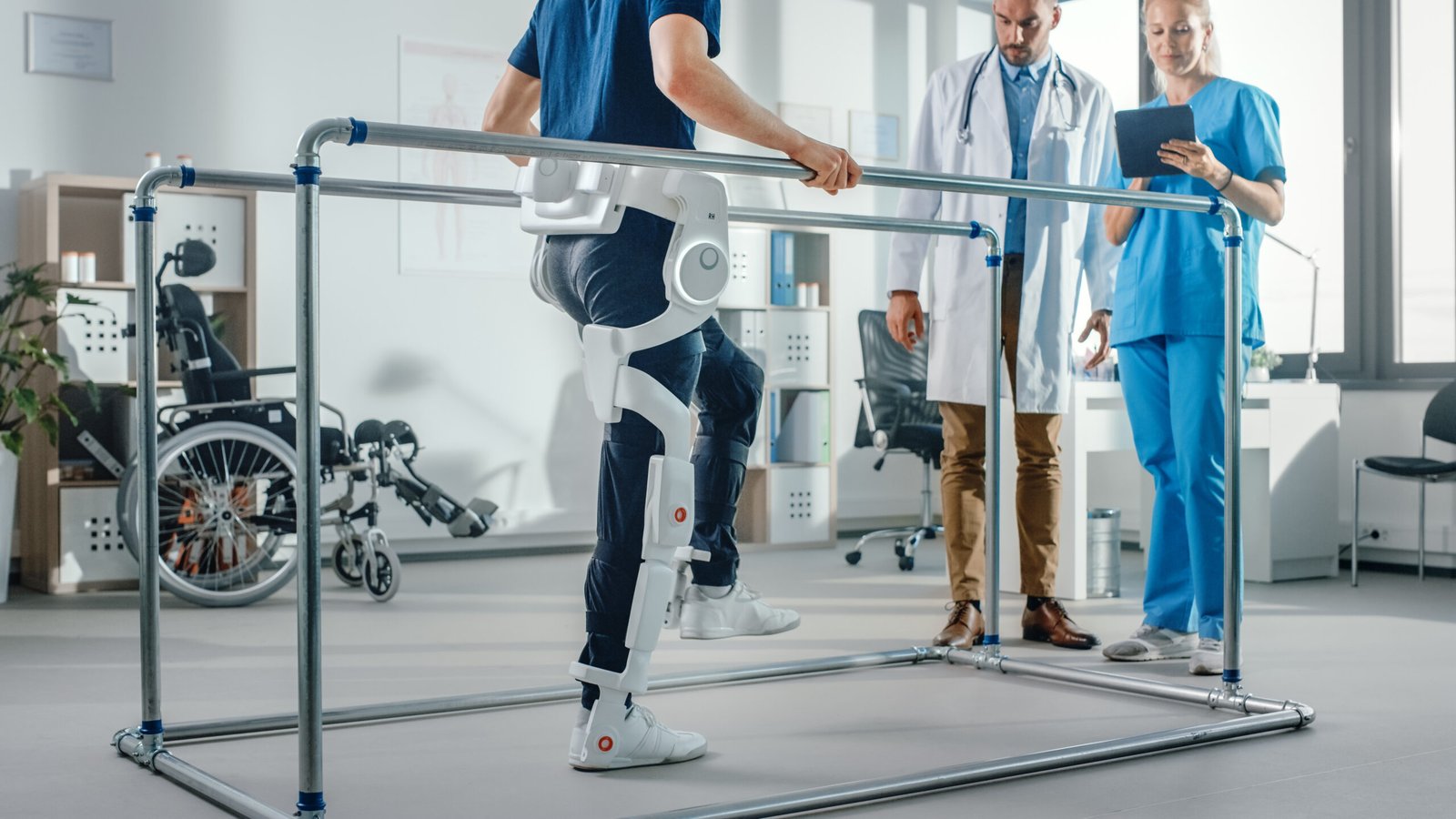 modern-hospital-physical-therapy-patient-with-injury-walks-wearing-advanced-robotic-exoskeleton-physiotherapy-rehabilitation-scientists-engineers-use-tablet-computer-help-disabled-person