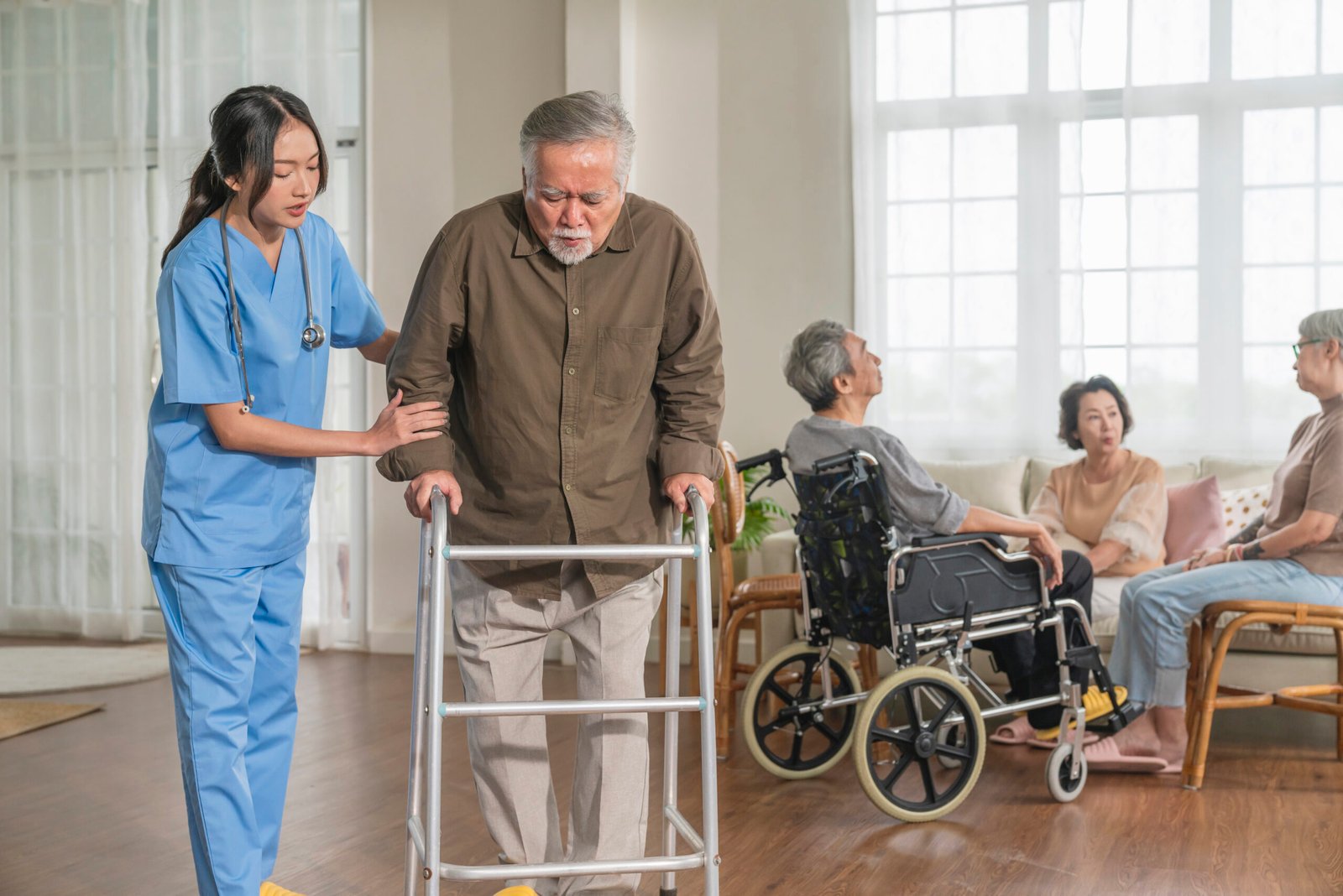 young asian female nurse care giver helping asian senior old man with mobility walker living area nursing home senior daycare centernurse take care elderly patient with cheerful concentrate scaled