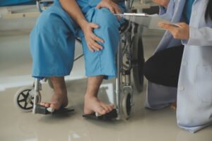 young-asian-physical-therapist-working-with-senior-woman-walking-with-walker
