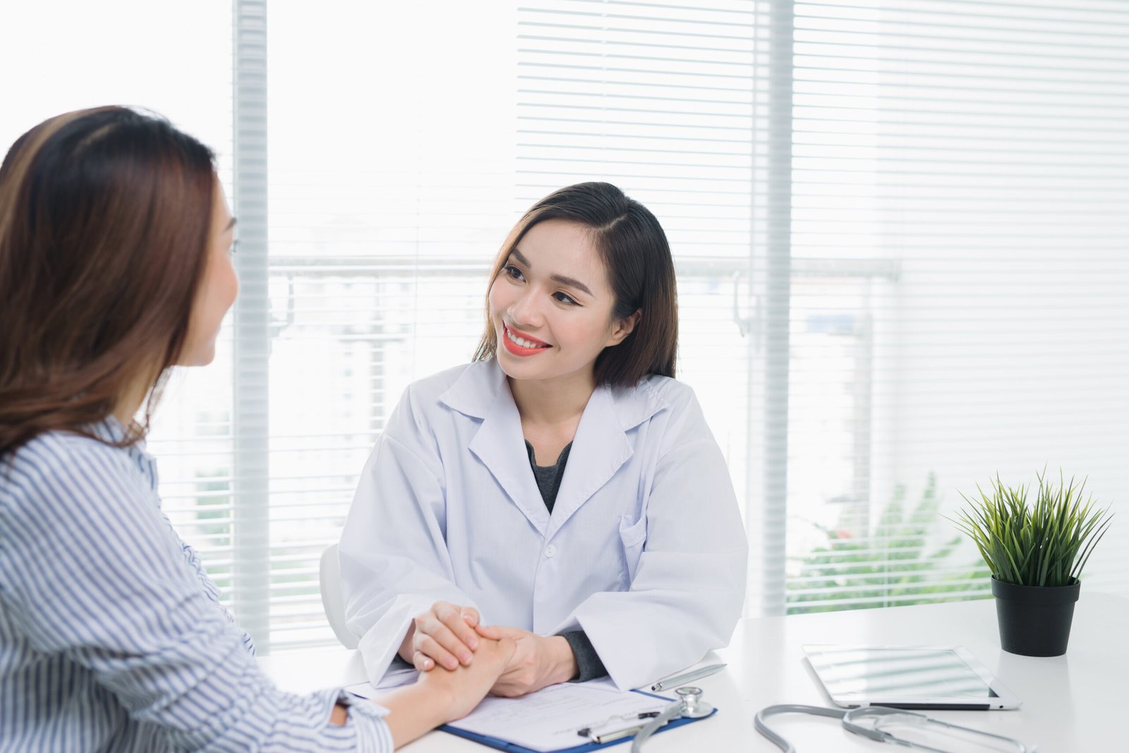 beautiful female doctor white medical coat doctor patient sitting desk near window hospital scaled