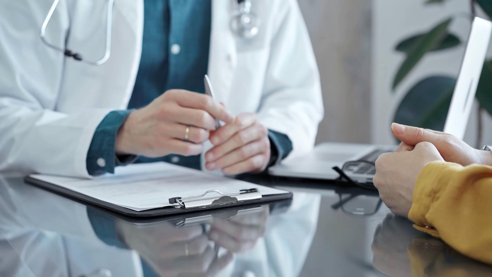 doctor patient consultation clinic patient listens attentively as doctor explains diagnosis modern medical office medicine health care scaled