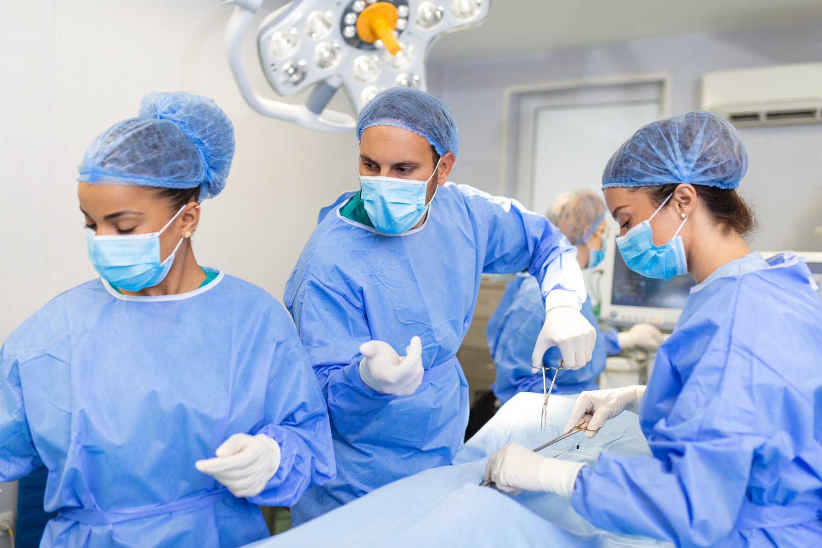 group medical team urgently doing surgical operation helping patient theater hospital medical team performing surgical operation bright modern operating room scaled