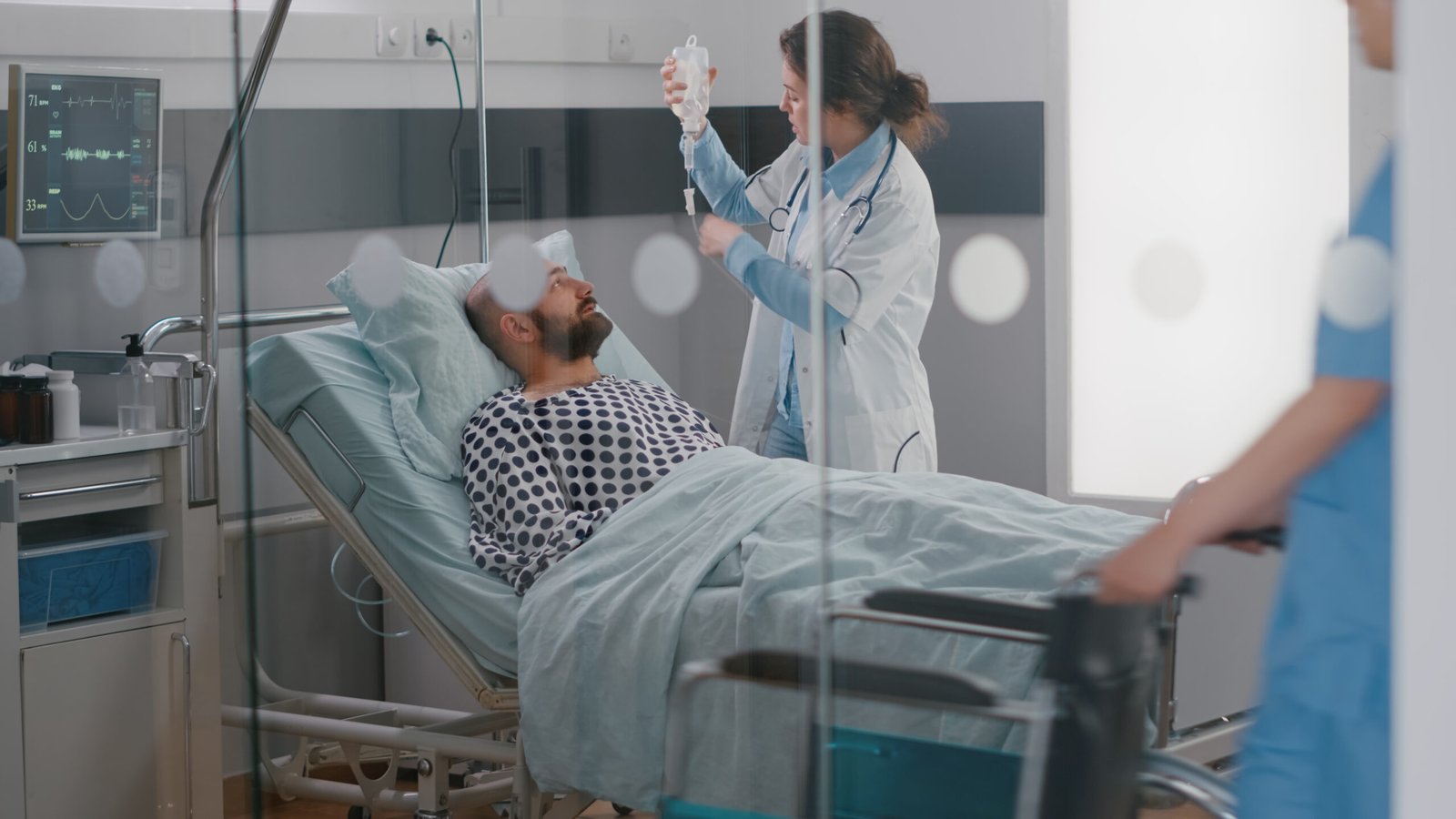 medical team monitoring patient vital checking heart rate helping with fluids scaled