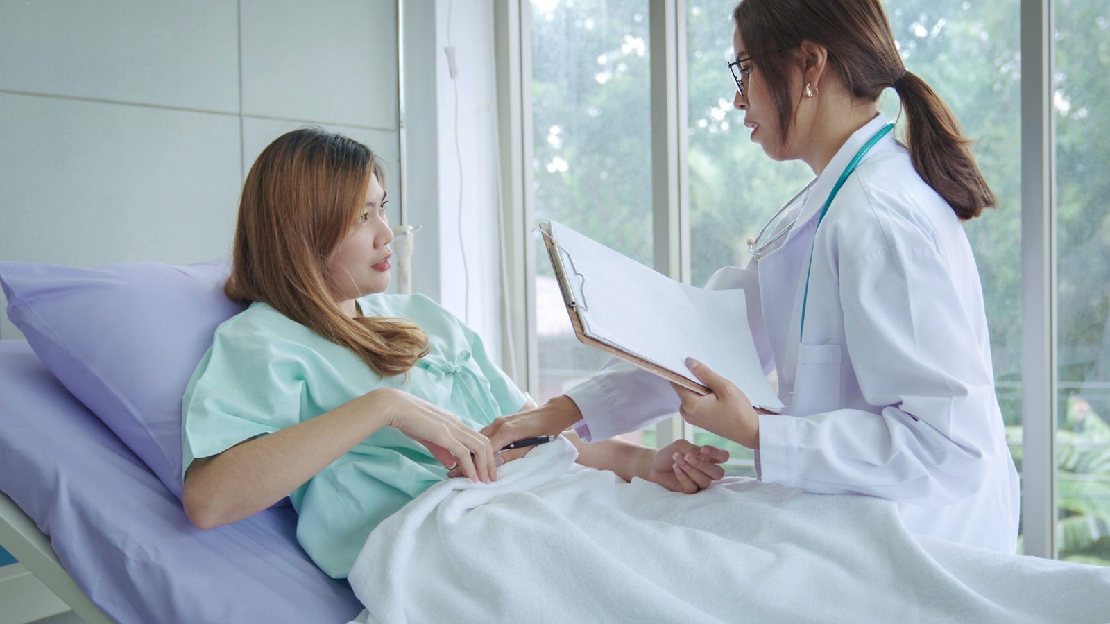 Vaginoplasty Recovery: What to Expect Week by Week (2026) 2 young doctor examining patient hospital scaled