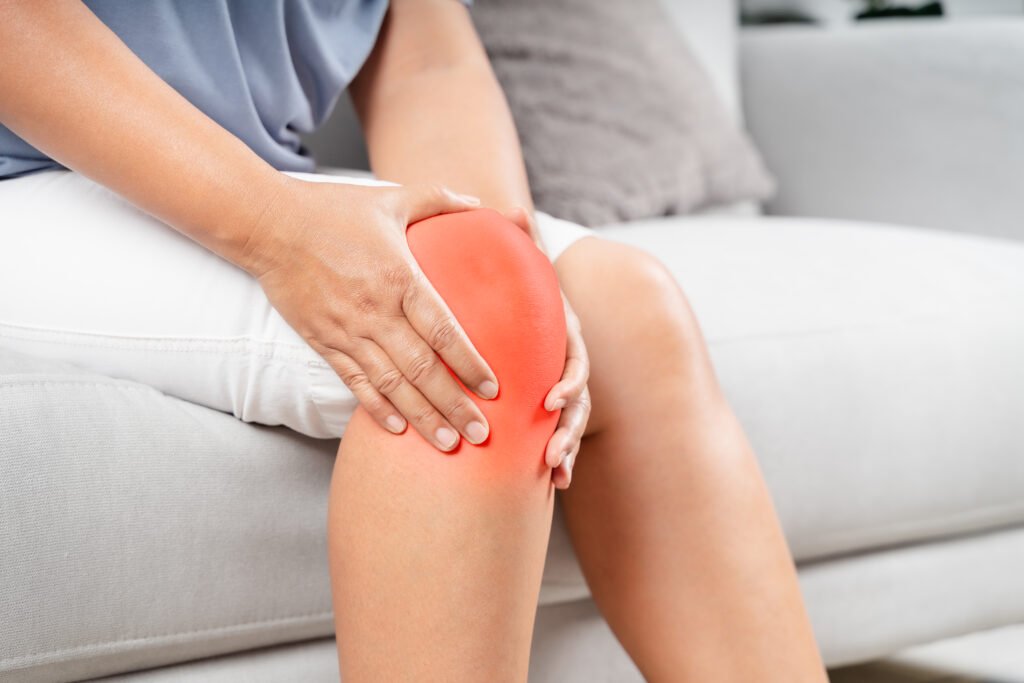 Swelling After Knee Replacement: What's Normal and What's Not 28 close up chubby woman sitting sofa feeling knee pain she massages her knee healthcare medical concept
