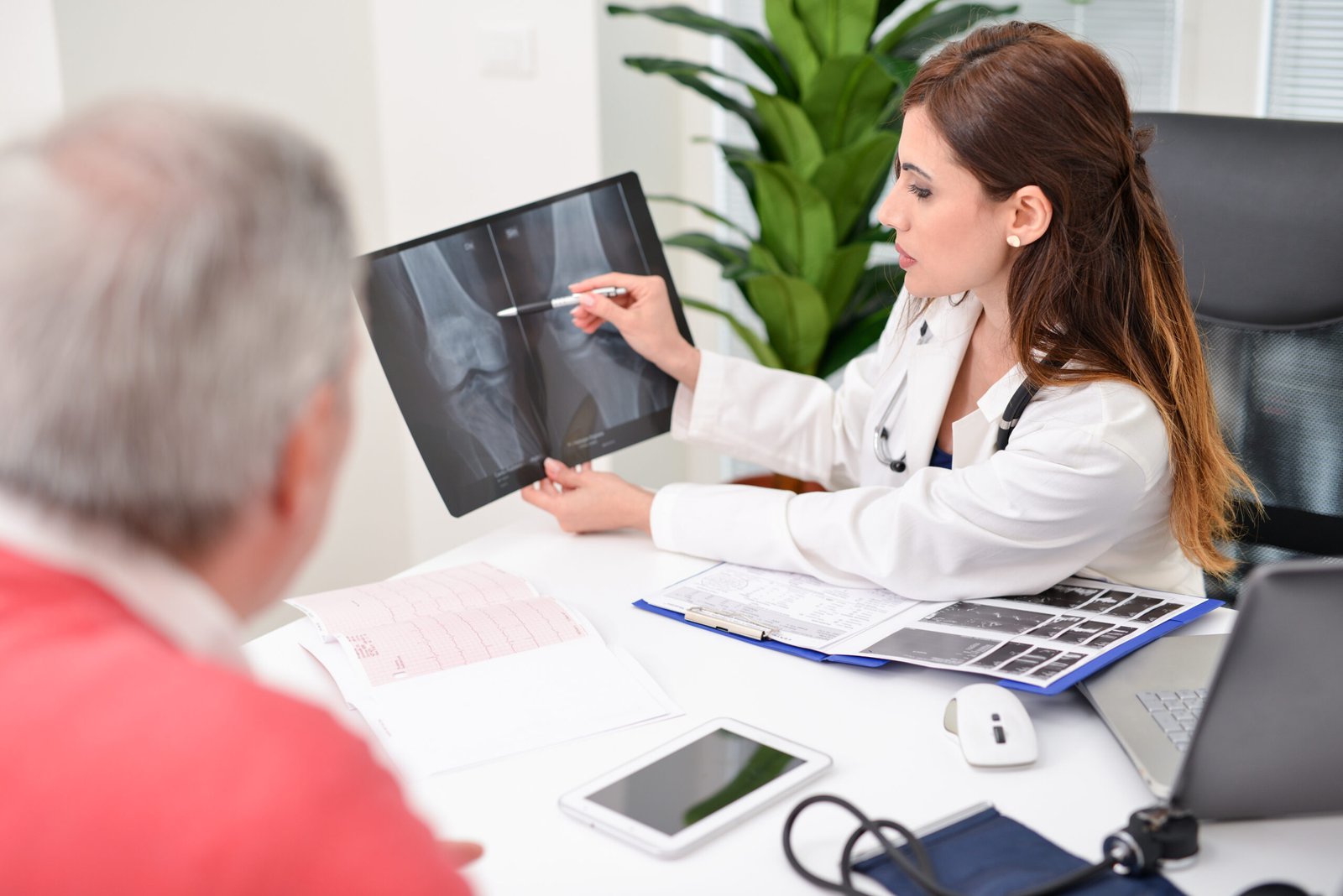 doctor showing radiography patient scaled