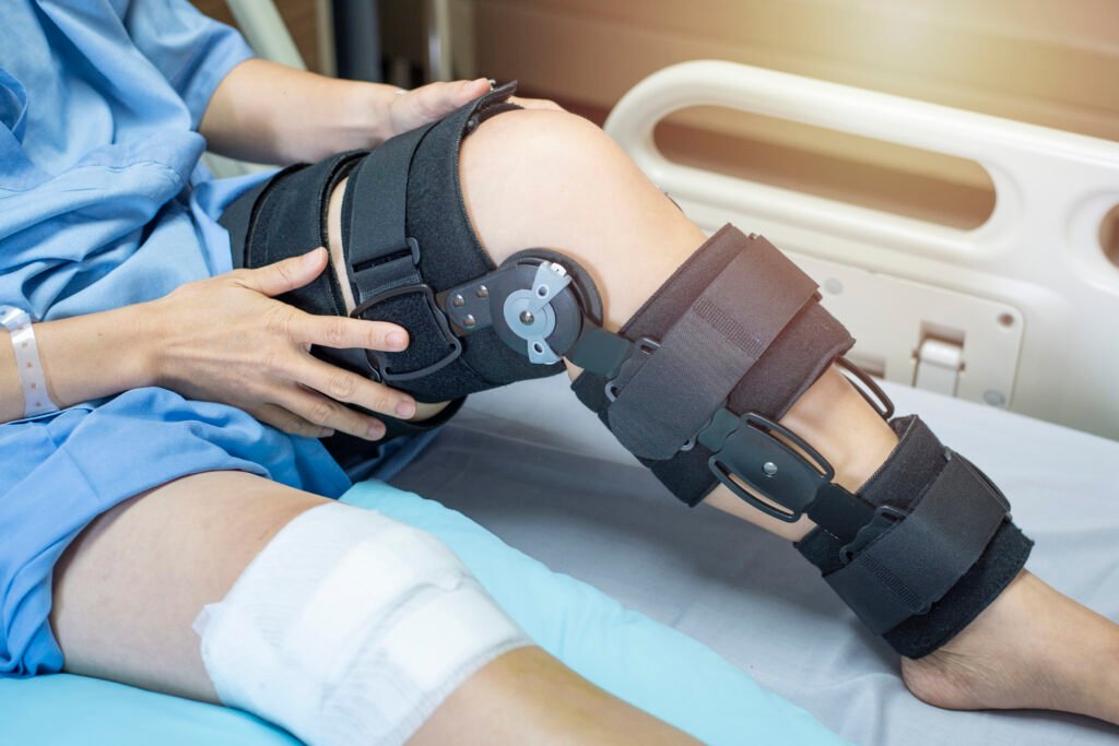 patient with bandage compression knee brace support injury bed nursing hospital healthcare medical support