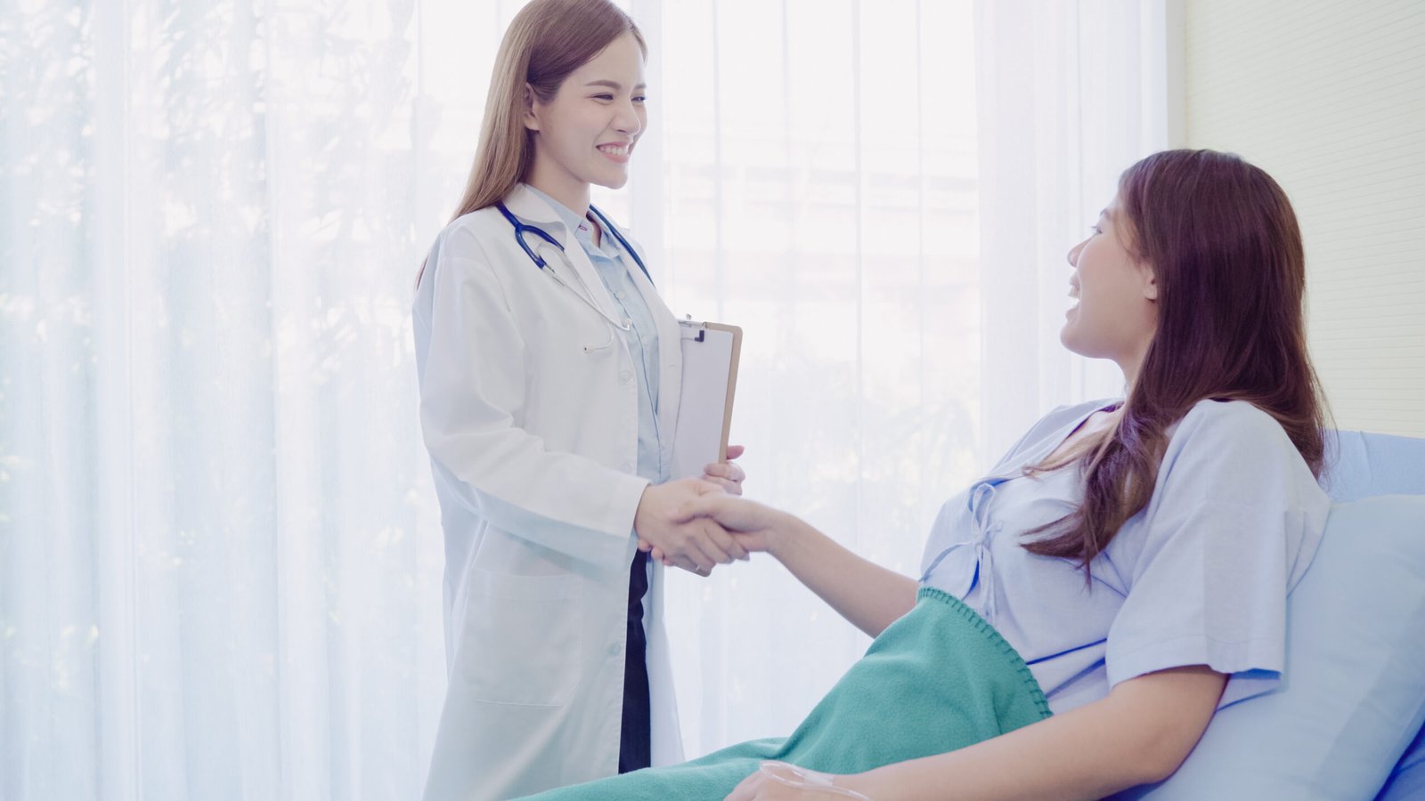 beautiful smart asian doctor patient discussing explaining something with clipboard scaled