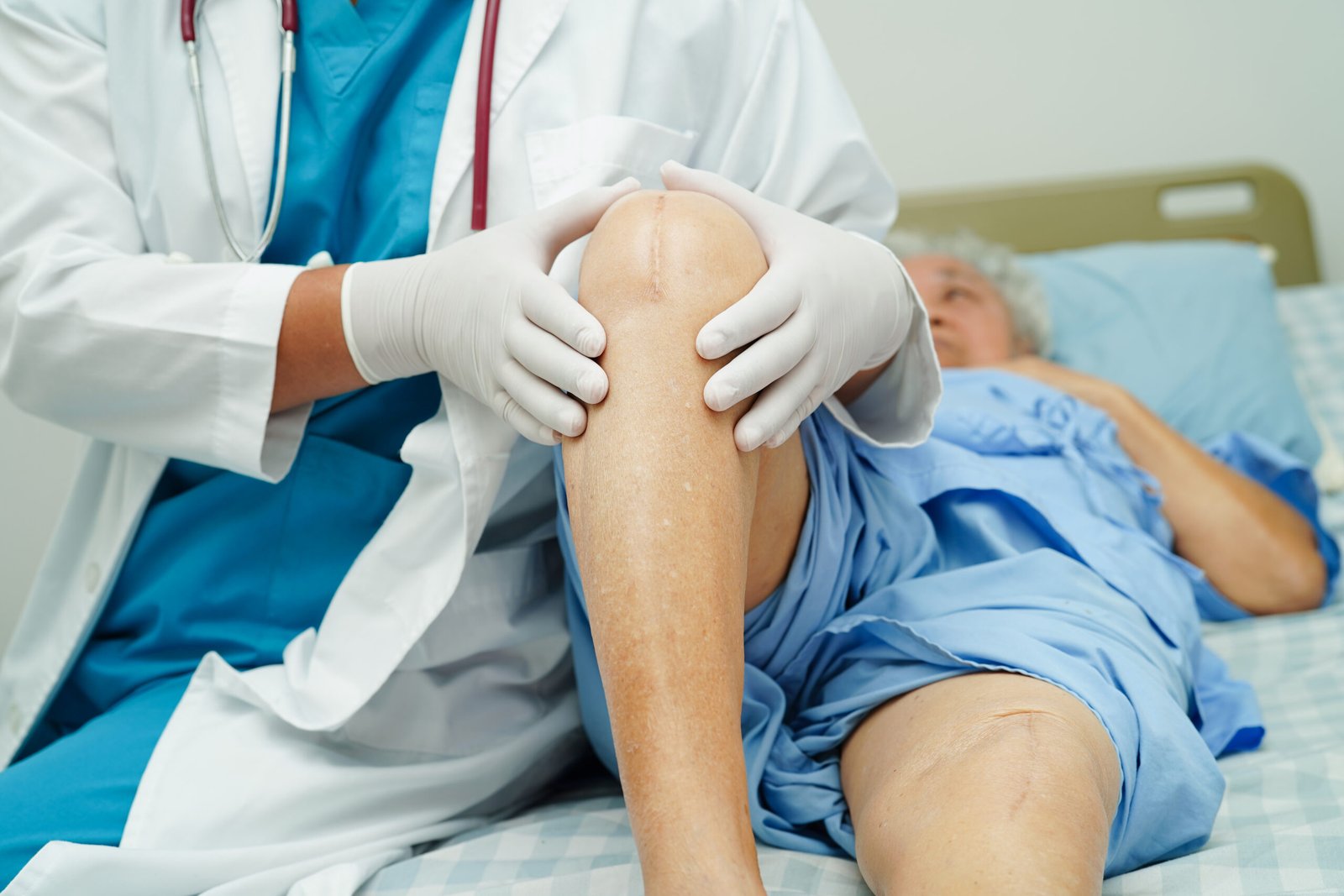 How Do You Know If You Need a Knee Replacement? 2 doctor checking asian elderly woman patient with scar knee replacement surgery hospital 1 scaled