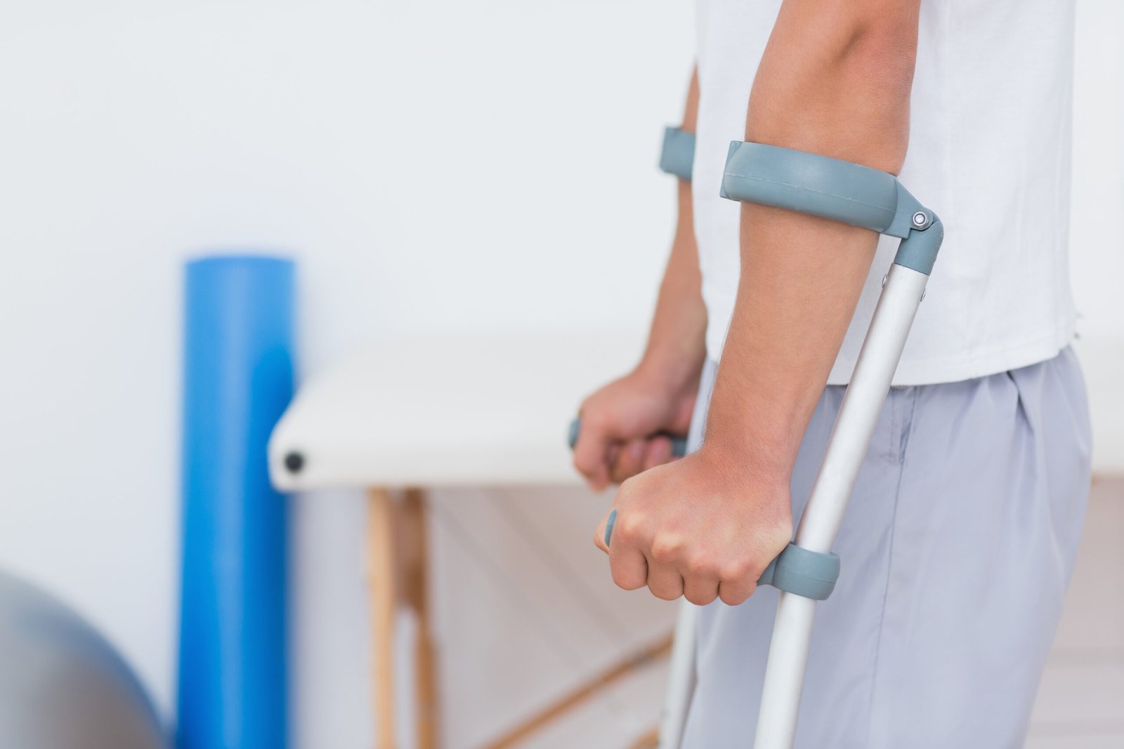 patient standing with crutch medical office 1 scaled