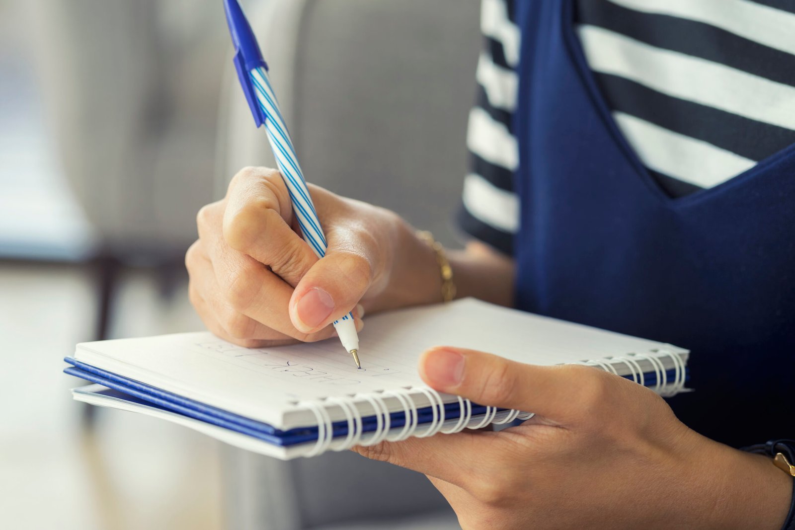 woman-hand-writing-check-list-notebook-planning-concept