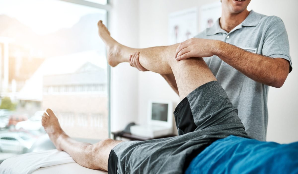 man-knee-injury-physiotherapist-working-consulting-room-rehabilitation-with-exercise-male-people-office-together-physiotherapy-service-with-health-insurance-joint-support